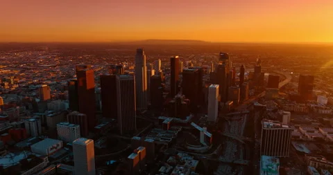 Orange light of sunset dazzling the panorama of Los Angeles, California, USA. Stock Footage 327033173