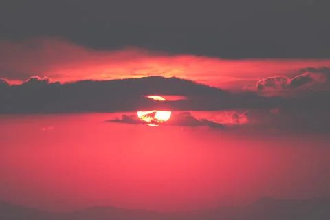 Orange light of the sunset over the mountain Stock Photos