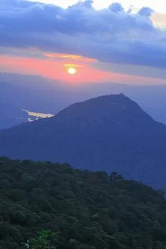 Orange light of the sunset over the mountain Stock Photos