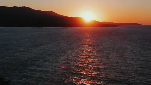 Orange light through to the cloud above the ocean Stock Footage 165628848