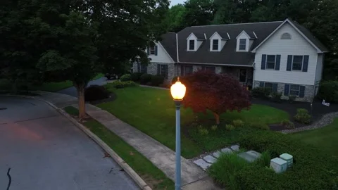 Orange lighting lantern on street in front of American single family house at Stock Footage 313183587