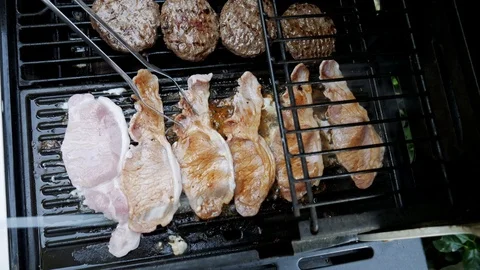 Orange liquid oozing out of bacon while being cooked on barbecue. Stock Footage 111931369