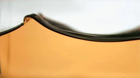 Orange liquid rippling in super slow motion Stock Footage 10859864