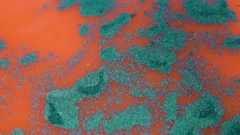 Orange Liquid Surface with Blue Shapeless Glitter Patterns, Glitter Paints on Wa Stock Footage 169931905
