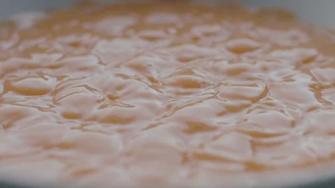 Orange Liquid Vibrate on Sounds Waves in Slow Motion Stock Footage 86422345