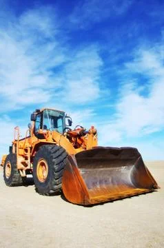 Orange loader bulldozer with cloud sky Stock Photos
