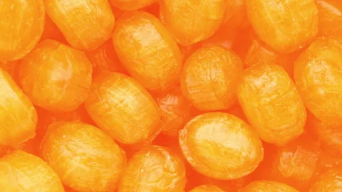 Orange lollipops, rotation in circle. Seamless loop. Stock Footage 245697691