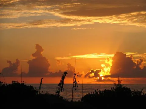 Orange magnetic sunset between the clouds 스톡 사진