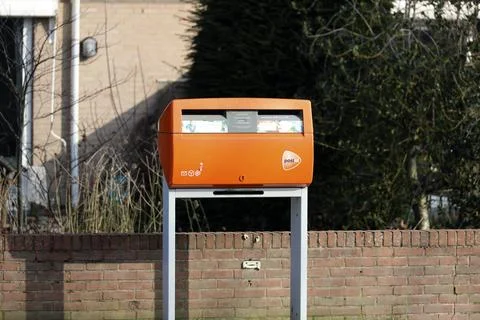 Orange mailbox of PTT Post in the Esse Hoog district of Nieuwerkerk aan den.. Stock Photos