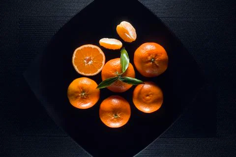 Orange mandarin on black background Stock Photos