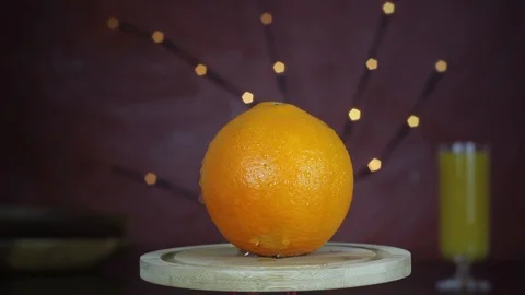 Orange, mandarin is rotating in the kitchen's platform.  Stock Footage 99898241