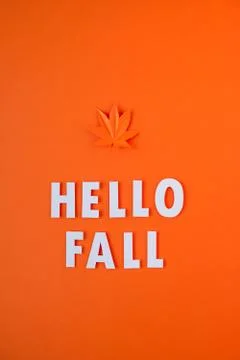 Orange maple leaf cut from paper on orange background Stock Photos