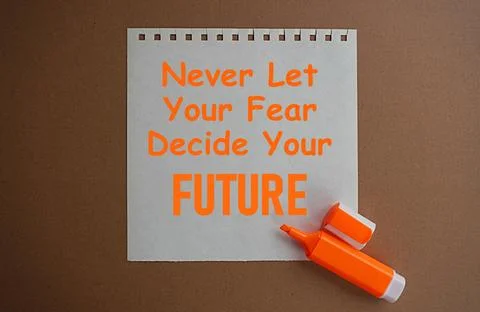 Orange marker and a note written never let your fear decide your future 写真素材