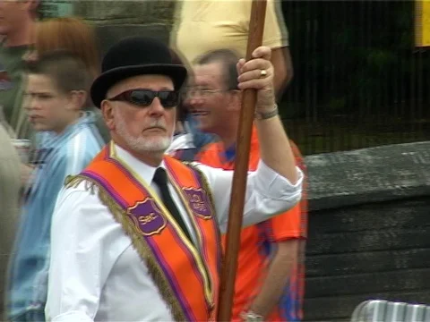 Orange masonic protestants marching holding a flag Stock Footage 77270292