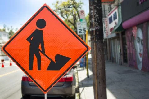 Orange Men at Work Sign on the Side of the Street Stock Photos