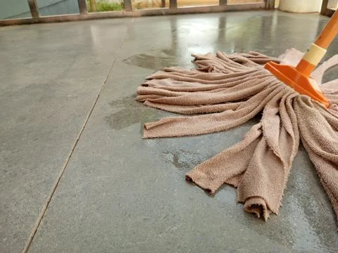An orange microfiber strip mop. Stock Photos