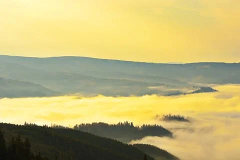 Orange mist on valleys just after the sunrise Stock Photos