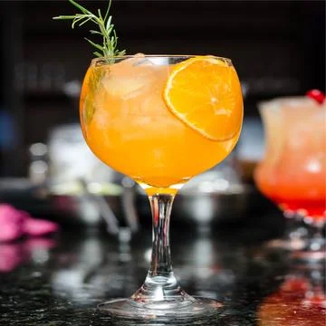 Orange mocktail with a lemon slice and blurred background 库存照片