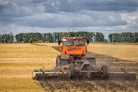 An orange modern tractor Stock Photos