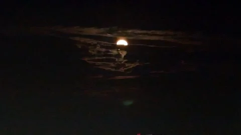 Orange moon among clouds Stock Footage 257718002