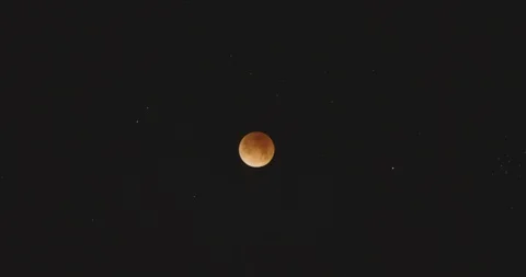 Orange Moon in Timelapse During an Eclipse It Enters and Exits the Frame Stock Footage 89293113