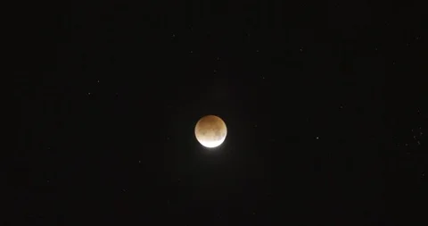 Orange Moon in Timelapse Entering An Eclipse Phase Stock Footage 89292287