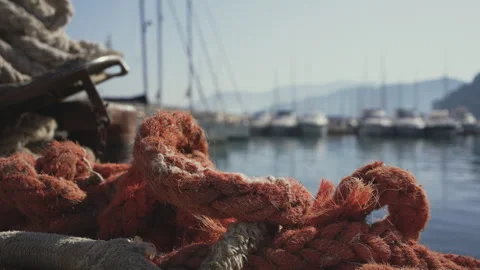 Orange mooring ropes left on the dock of the Agropoli's harbor Video stock 278890399
