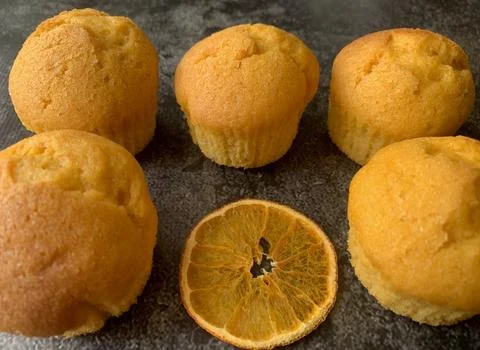 Orange muffins on a black background Stock Photos