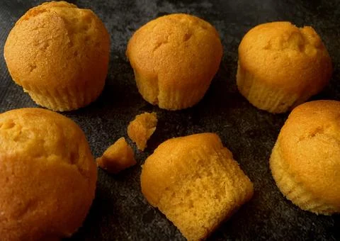 Orange muffins on a black background Stock Photos