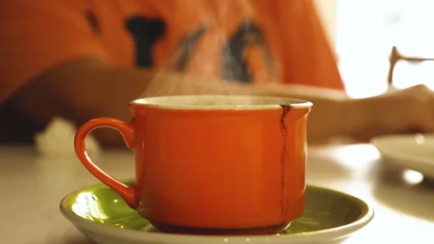 orange-mug-hot-coffee-table-footage-2197