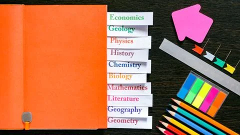 Orange notebook with the name of school subjects Stock Photos