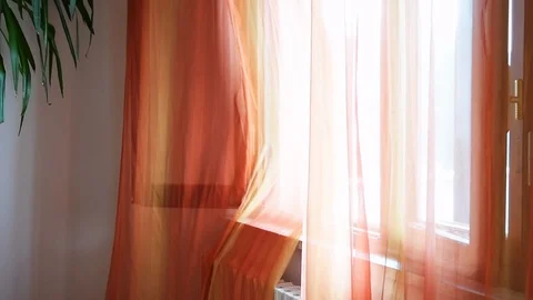 Orange open window curtains blinds in room interior flowing in wind in Italy Stock Footage 117030797