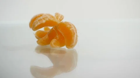Orange or tangerine slices falling on white background Stock Footage 87436710