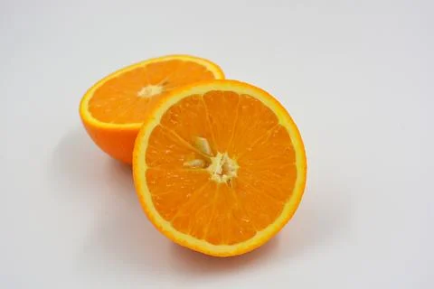 Orange oranges cut into two halves. Juicy fresh fades of orange with bones. Stock-Fotos