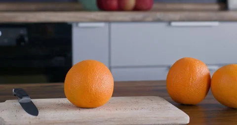 Orange oranges on the table in the kitchen, the video camera moves in a circle Video stock 250822356
