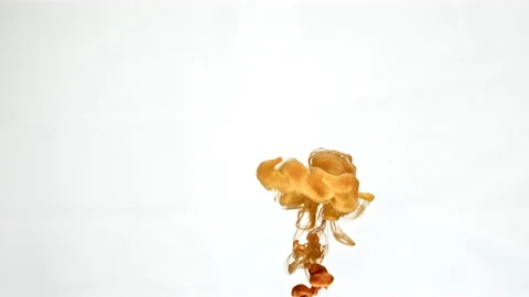 Orange paint bursts in water Video stock 165500845