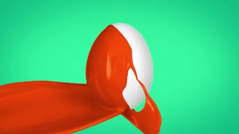 Orange paint pours onto white egg on green background in slow motion clip Stock Footage 327594222