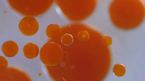 Orange Paint Spheres in Liquid Stock Footage 125547452