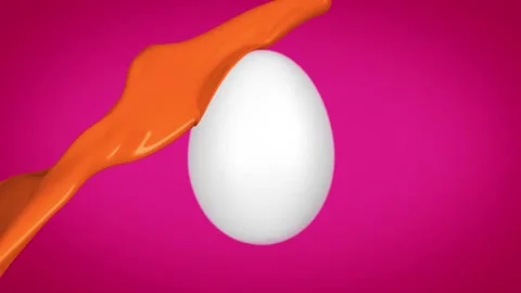 Orange paint splash on white egg creating dynamic and artistic paint flow Stock Footage 327594231