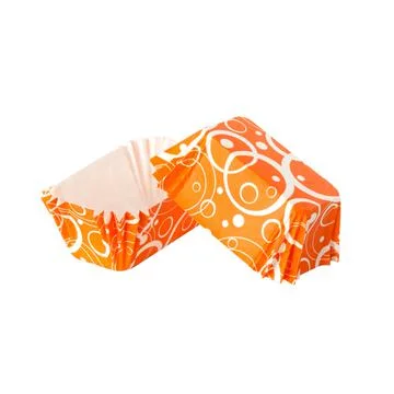 Orange paper baking forms for cakes with abstract pattern Foto stock