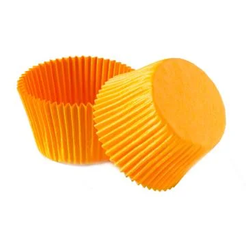 Orange paper baking forms for muffins and cupcakes Stock Photos
