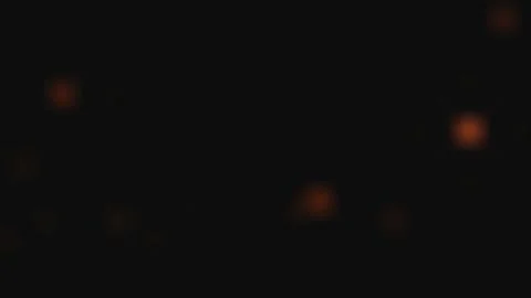 Orange particles float gently in darkness with subtle motion blur during a .. Stock Footage 340939922