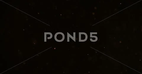 Orange particles like spark slowly float in air Stock Photos