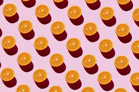 Orange pattern on a light pink background. Pop art design, creative citruses Stock Photos