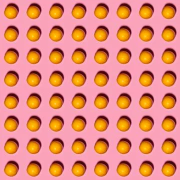 Orange pattern on pink background. Creative food concept. Flat lay Stock Photos