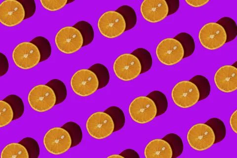 Orange pattern on a purple background. Pop art design, creative citruses. Yellow Stock Photos