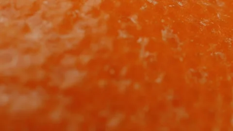 Orange peel surface close up rotating camera motion stock footage Stock Footage 337092307