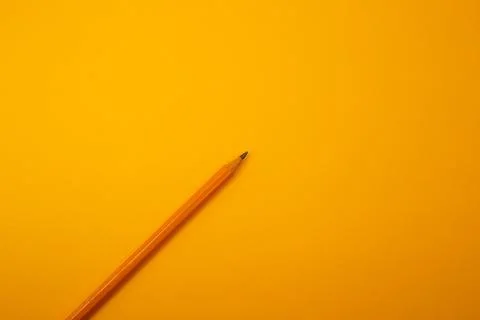 Orange pencil on a bright background Stock Photos