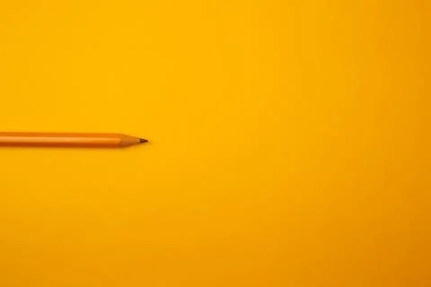 Orange pencil on a bright background Stock Photos
