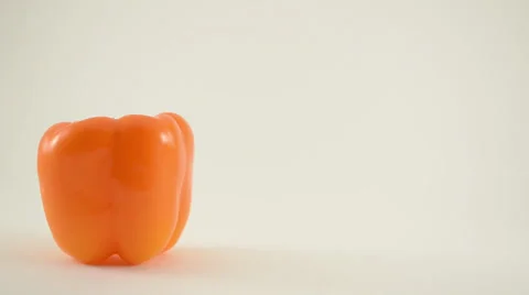 Orange Pepper Against White - Crane Down Stock Footage 22648733